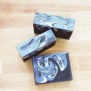 Black charcoal soap with white and blue swirls
